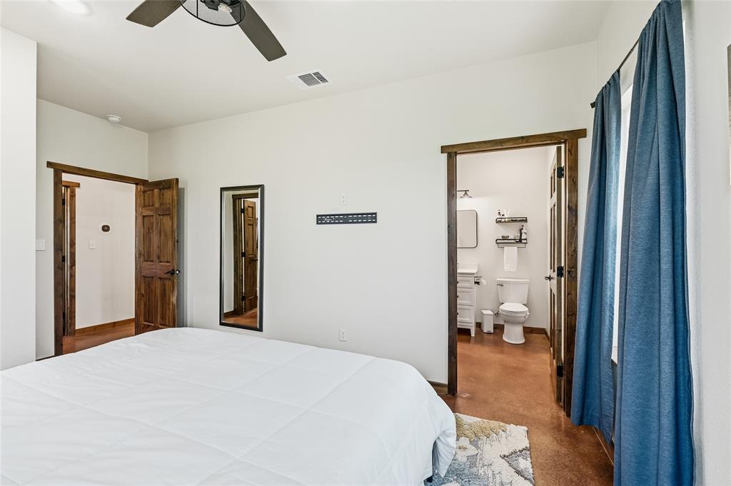 435 County Road 4875 Celeste, TX 75423 - Photo 17 of 35 a bedroom with a bed and a chandelier