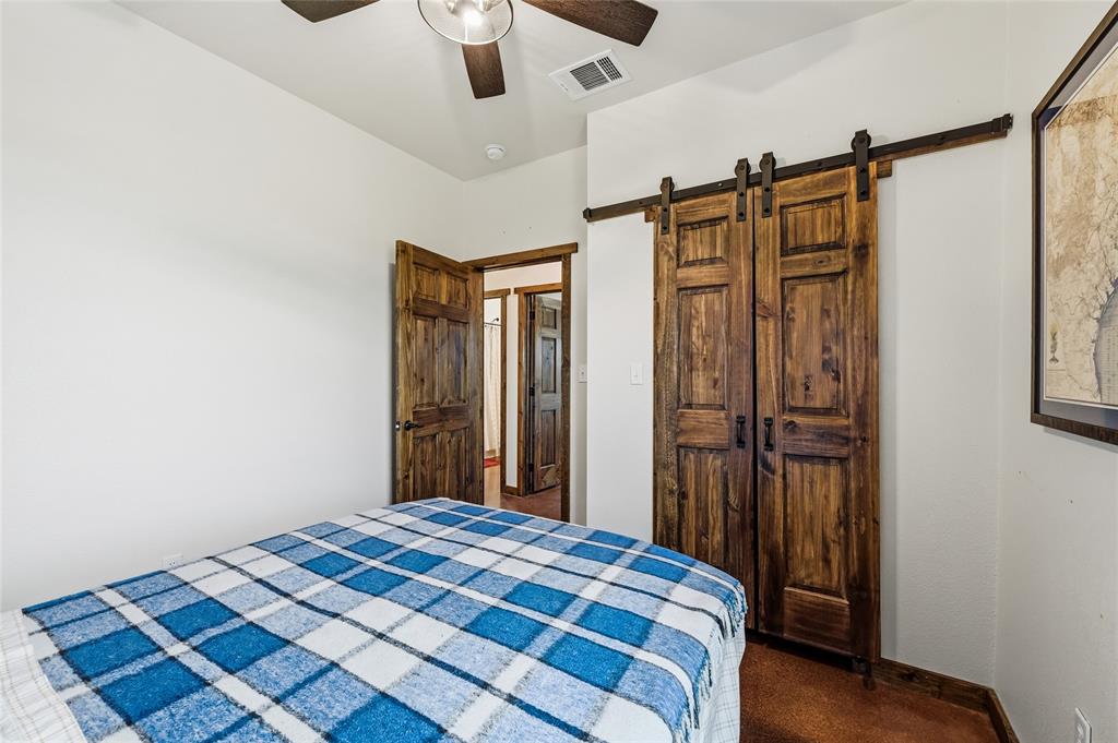 435 County Road 4875 Celeste, TX 75423 - Photo 21 of 35 a bedroom with a bed and a mirror