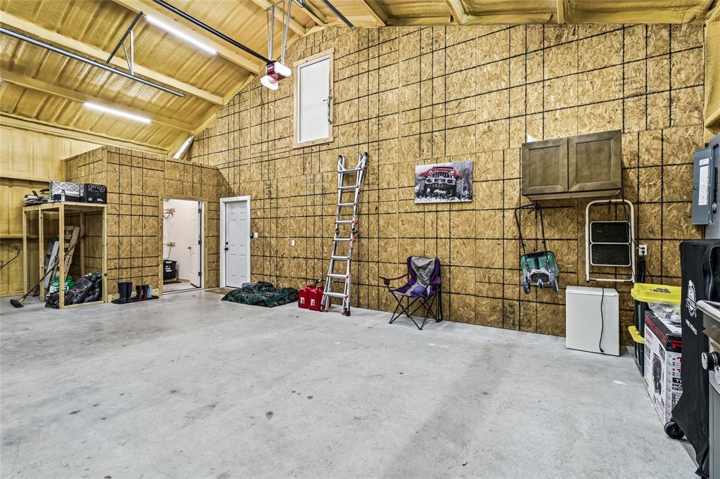 435 County Road 4875 Celeste, TX 75423 - Photo 27 of 35 a view of a blue garage with a chair and potted plant