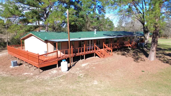 a view of a roof deck with wooden fence and a couple of chairs