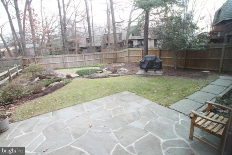 8111 Inverness Ridge Road Potomac, MD 20854 - Photo 14 of 17 a backyard of a house with lots of green space and fountain