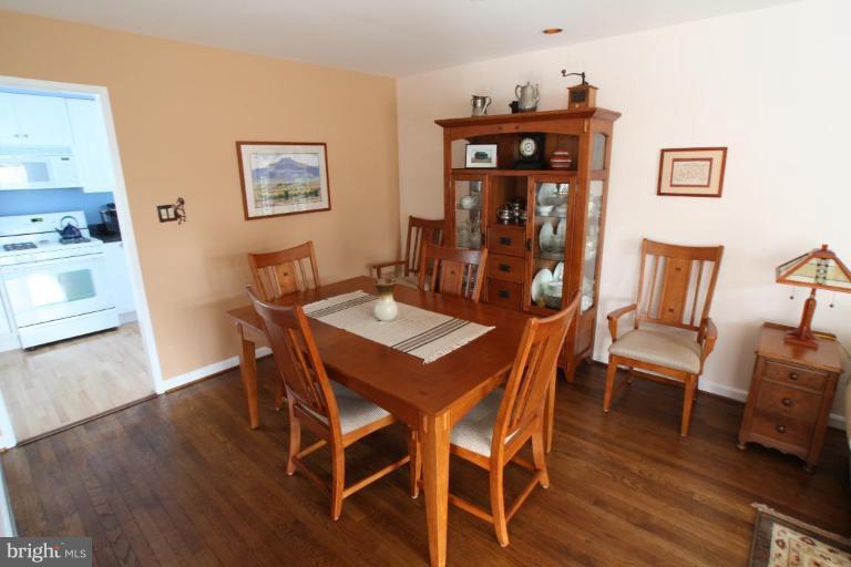8111 Inverness Ridge Road Potomac, MD 20854 - Photo 5 of 17 a view of a dining room with furniture and wooden floor