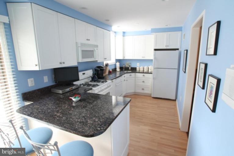 8111 Inverness Ridge Road Potomac, MD 20854 - Photo 6 of 17 a kitchen with a refrigerator sink and cabinets