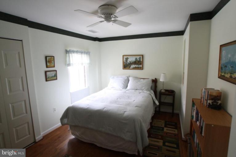 8111 Inverness Ridge Road Potomac, MD 20854 - Photo 10 of 17 a bedroom with a bed and a painting on the wall
