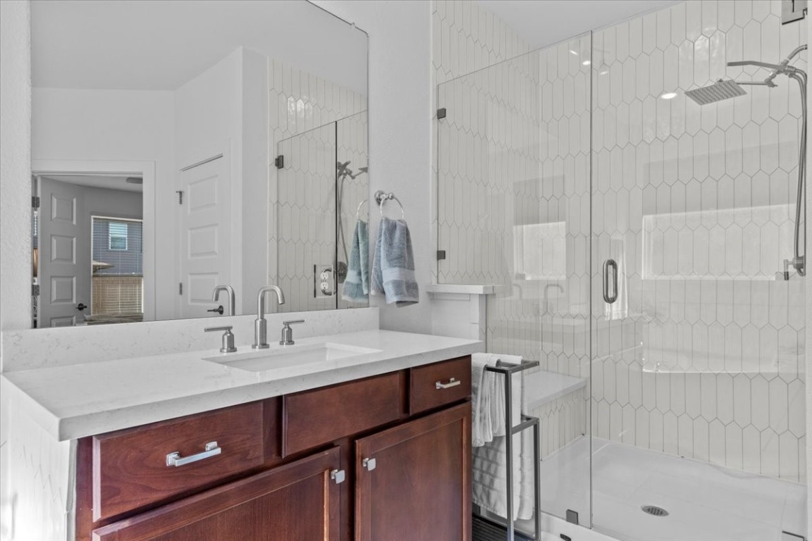 7701 Ellas Inlt Drive Austin, TX 78744 - Photo 10 of 27 a bathroom with a sink and a mirror