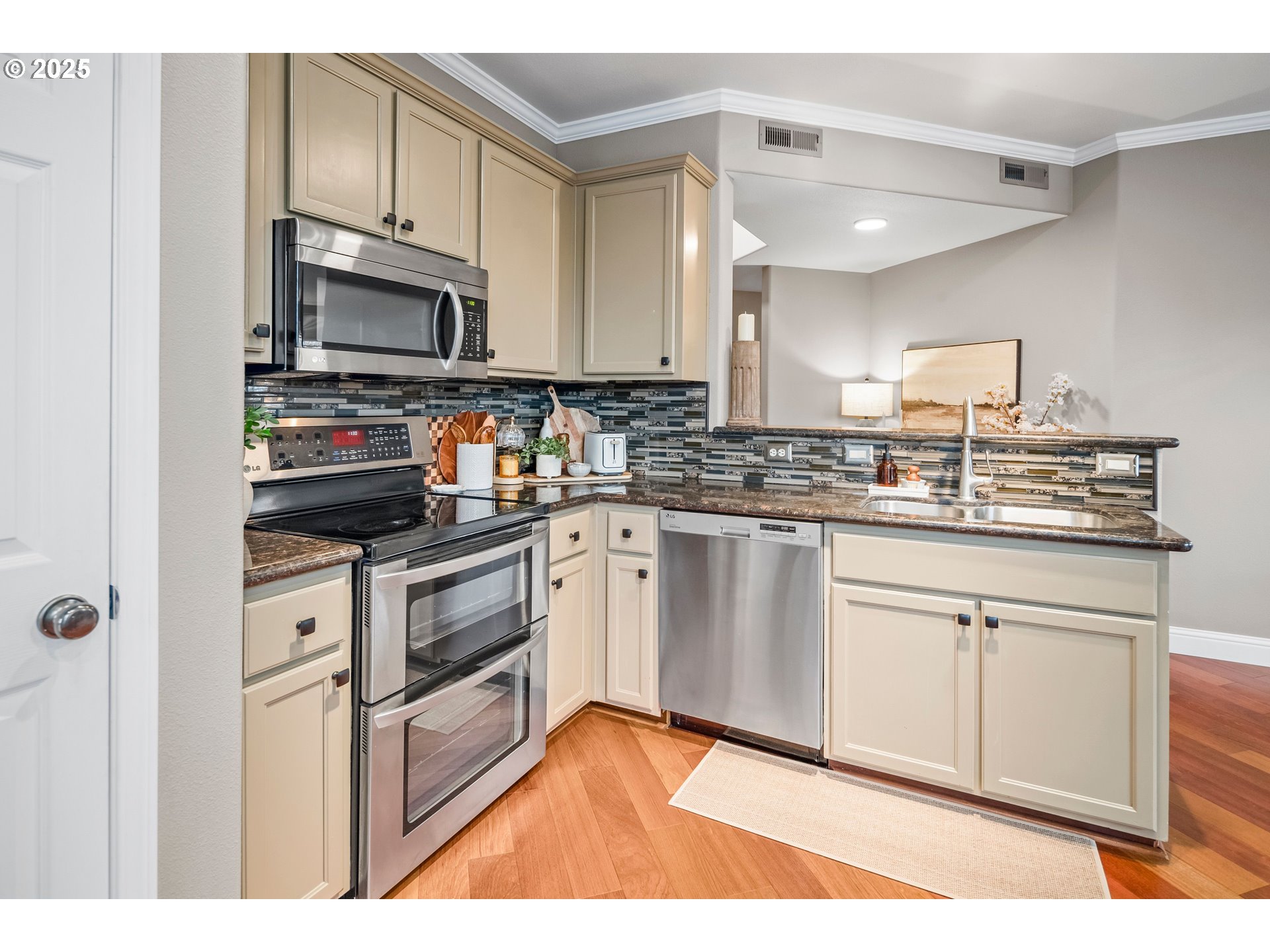 975 Springtree Lane West Linn, OR 97068 - Photo 18 of 48 a kitchen with white cabinets stainless steel appliances and sink