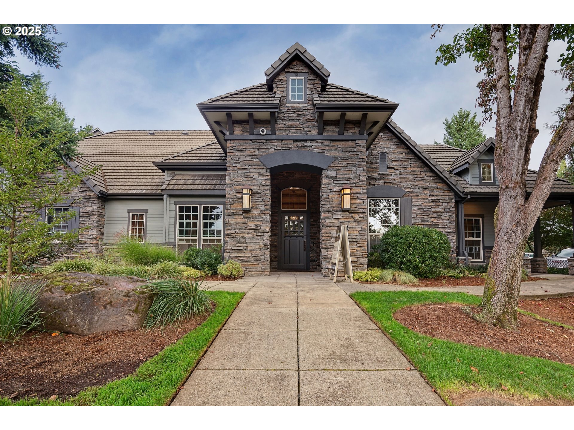 975 Springtree Lane West Linn, OR 97068 - Photo 37 of 48 a view of a house with a small yard plants and a large tree