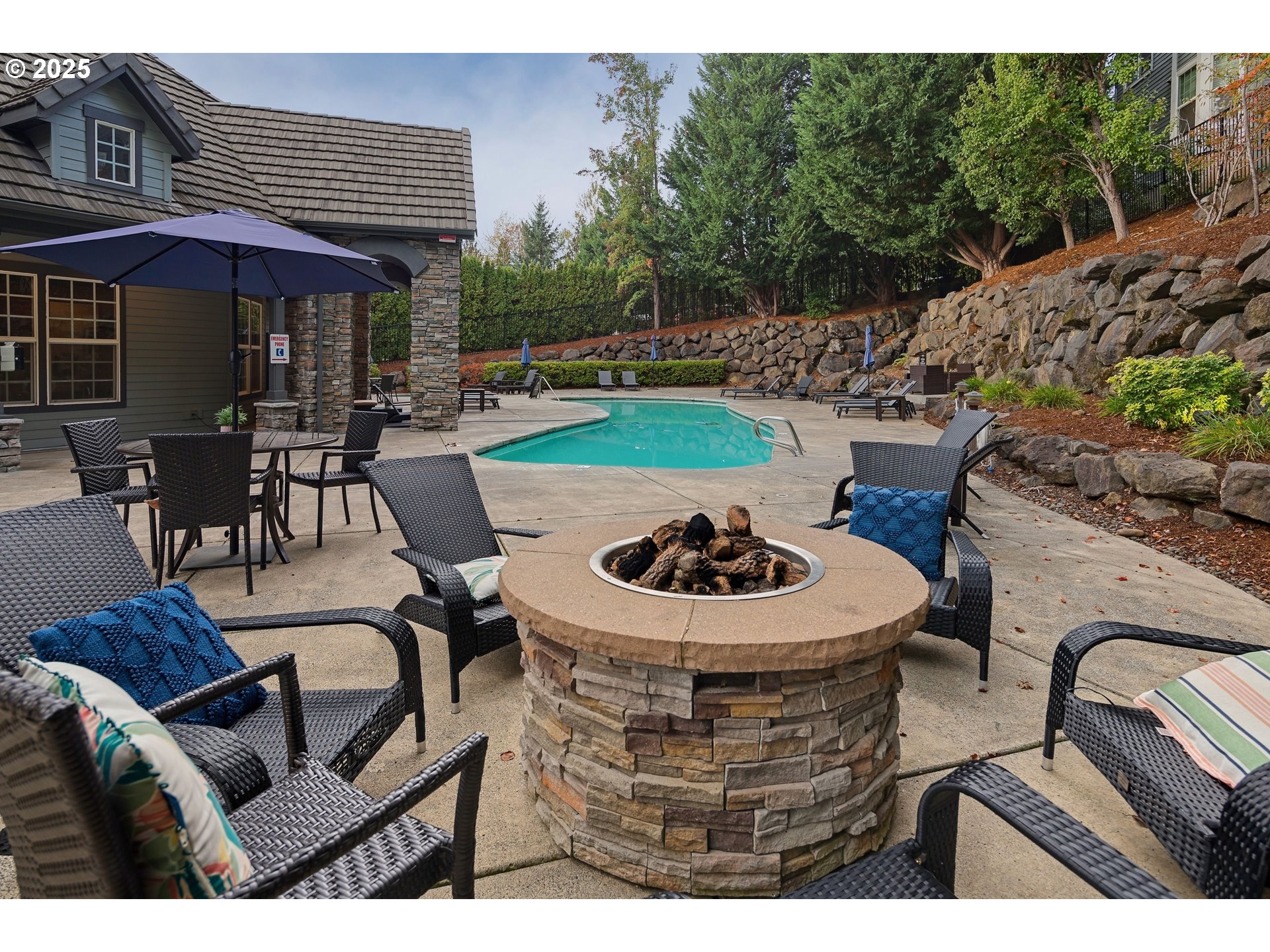 975 Springtree Lane West Linn, OR 97068 - Photo 45 of 48 a view of a patio with couches table and chairs under an umbrella