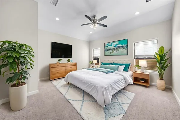 a bedroom with a bed and a couch