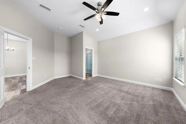 a view of a livingroom with a ceiling fan and window