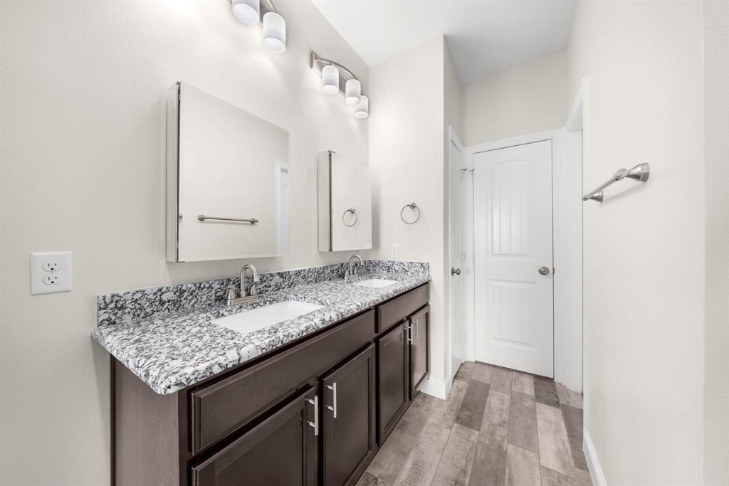11729 County Road 313 Terrell, TX 75161 - Photo 15 of 25 a bathroom with a granite countertop sink and a mirror