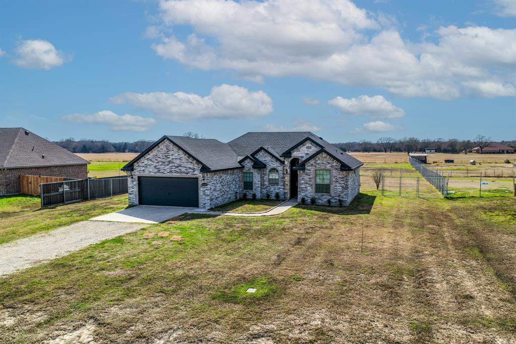 11729 County Road 313 Terrell, TX 75161 - Photo 24 of 25 a front view of a house with a yard and garage