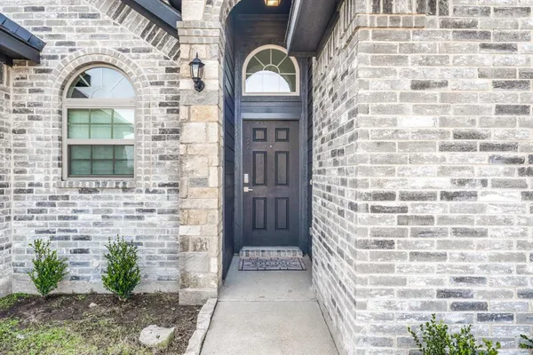 a view of a brick house with large windows