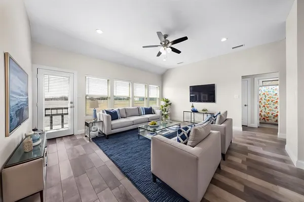 a living room with furniture and a flat screen tv
