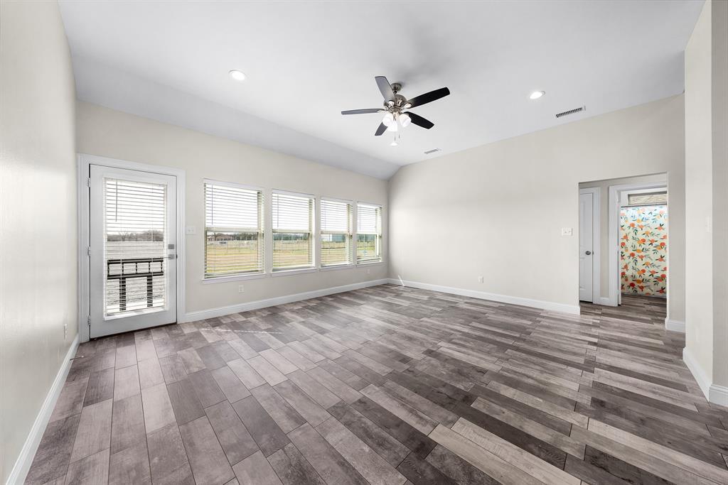 11729 County Road 313 Terrell, TX 75161 - Photo 7 of 25 a view of an empty room with a window and wooden floor