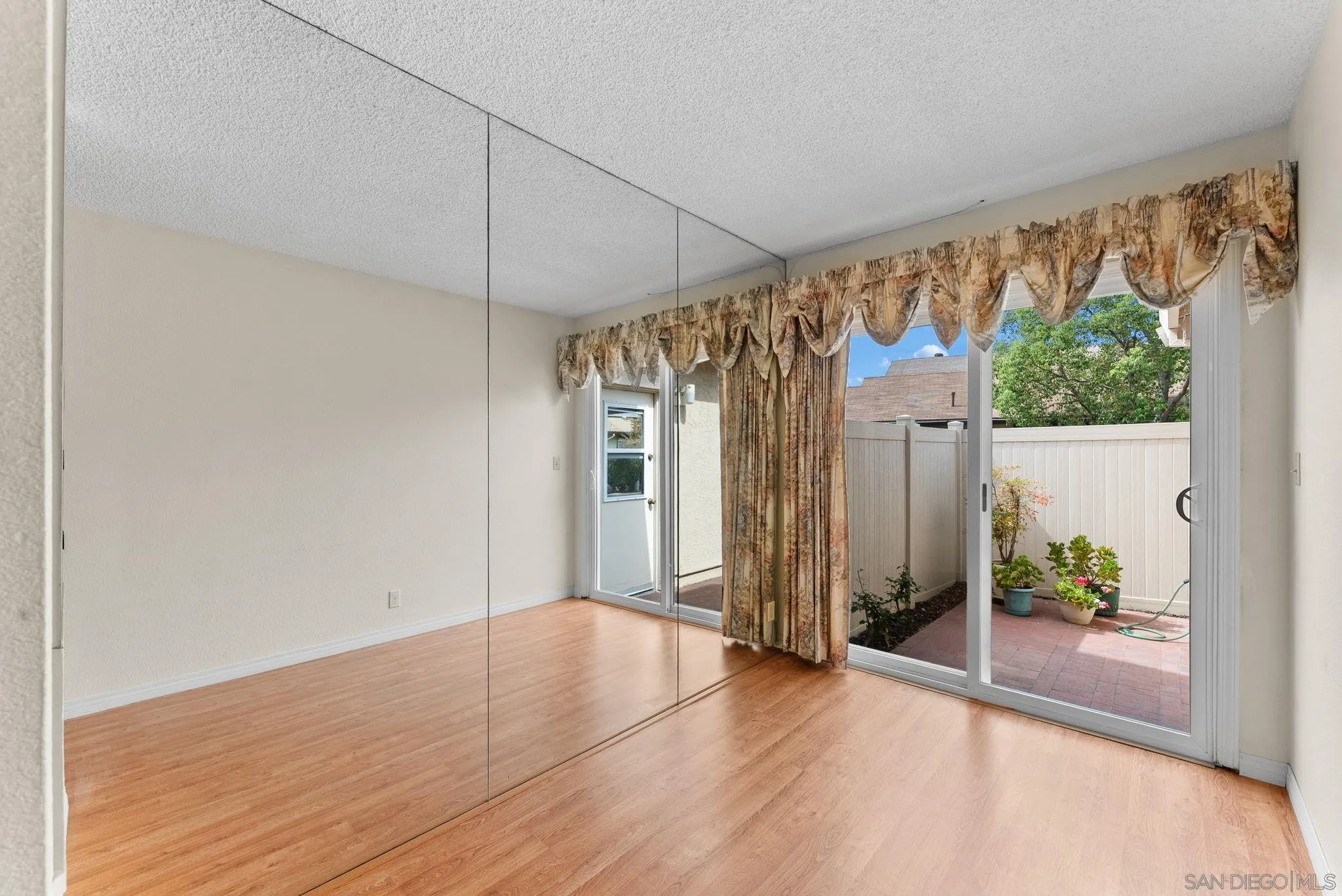 10357 Bart Way Santee, CA 92071 - Photo 18 of 39 an empty room with wooden floor and windows