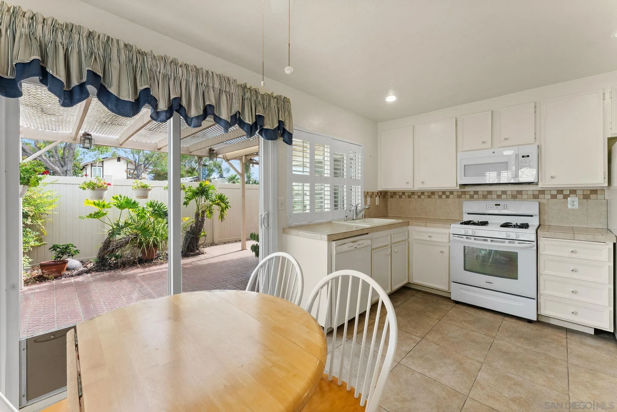 10357 Bart Way Santee, CA 92071 - Photo 7 of 39 a kitchen with a table chairs stove and cabinets