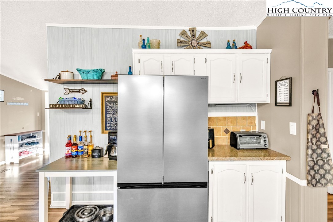 747 Nathans Creek School Road Crumpler, NC 28617 - Photo 15 of 42 a kitchen with stainless steel appliances a refrigerator and a stove