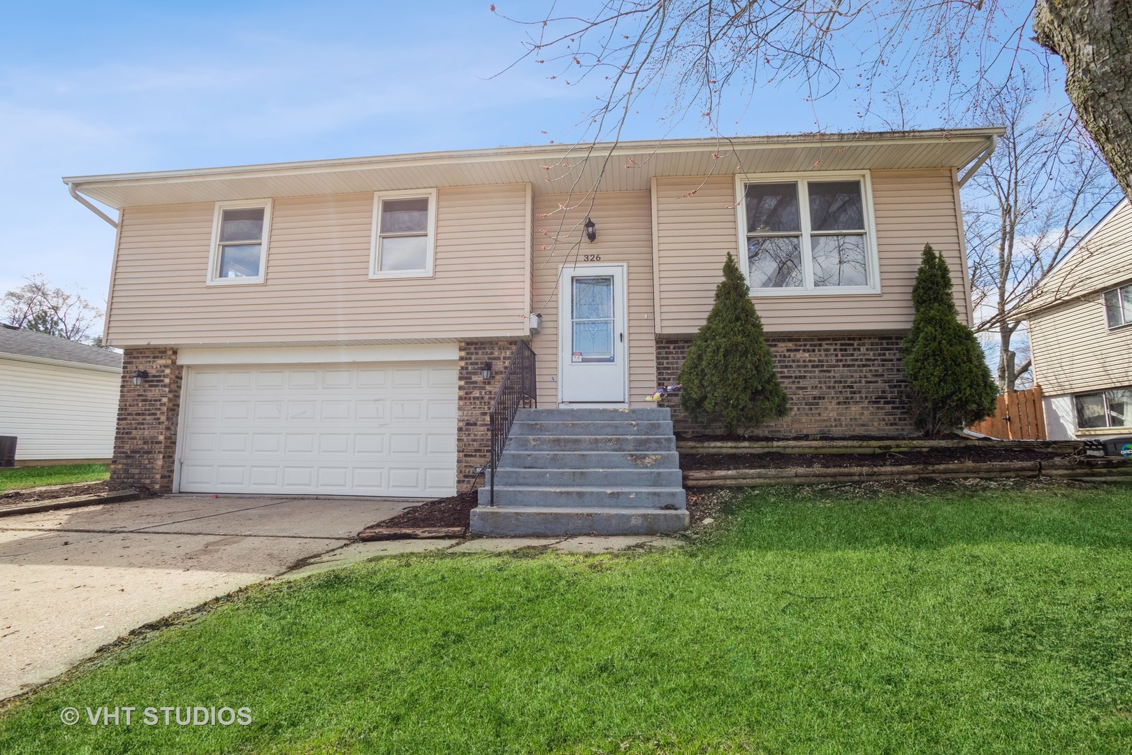 326 Brunswick Court Streamwood, IL 60107 - Photo 1 of 10 a front view of a house with a garden