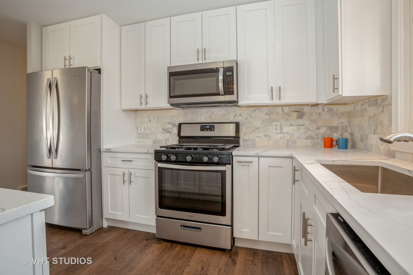 326 Brunswick Court Streamwood, IL 60107 - Photo 3 of 10 a kitchen with stainless steel appliances white cabinets a stove a microwave and a refrigerator
