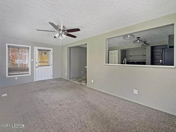 a view of a livingroom with furniture and chandelier fan