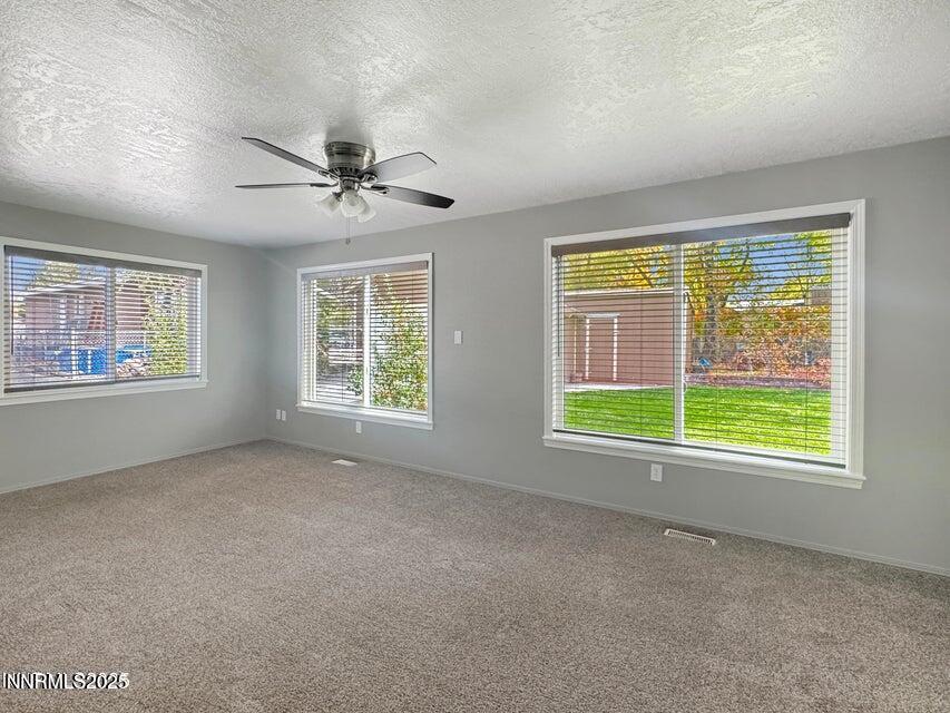 121 West Shepard Street Winnemucca, NV 89445 - Photo 12 of 14 a view of an empty room with windows and chandelier fan