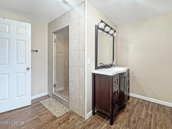 a bathroom with a sink a mirror and a shower
