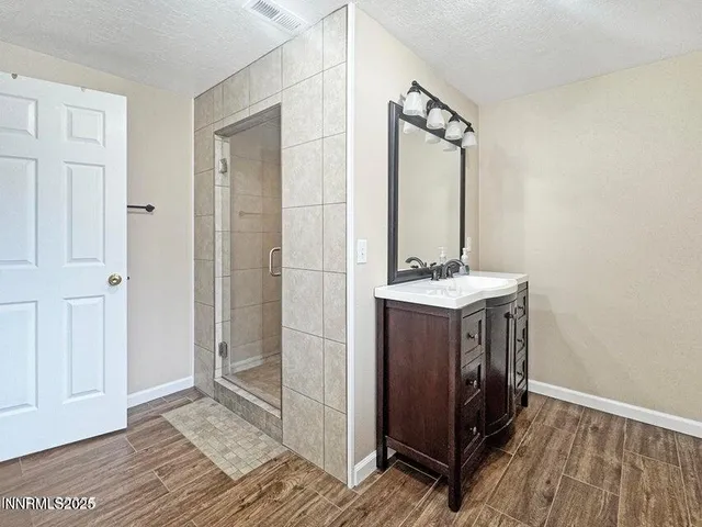 a bathroom with a sink a mirror and a shower