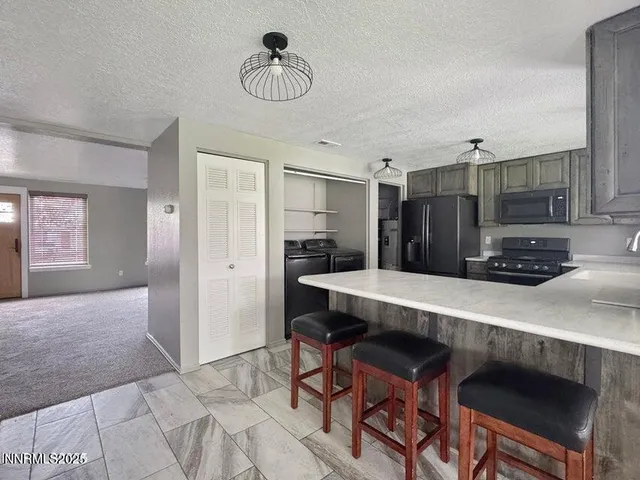 a view of kitchen with furniture and wooden floor