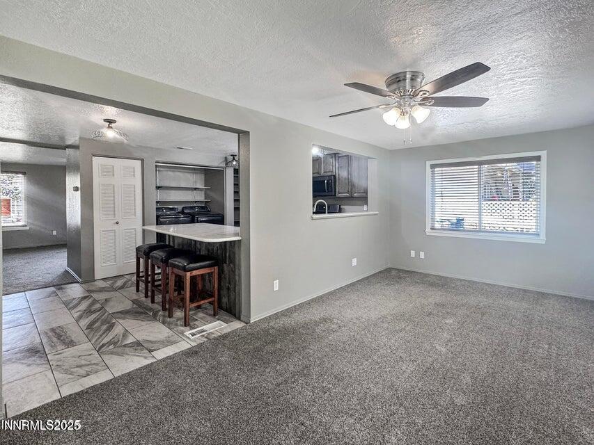 121 West Shepard Street Winnemucca, NV 89445 - Photo 5 of 14 a view of a livingroom with furniture a ceiling fan and window