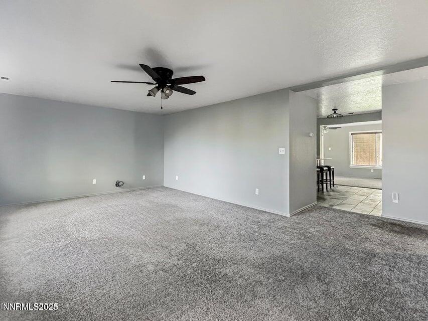 121 West Shepard Street Winnemucca, NV 89445 - Photo 8 of 14 an empty room with chandelier fan and windows