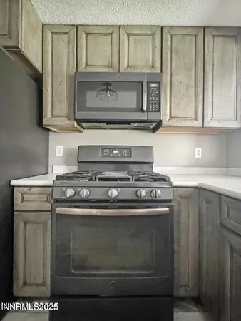 a stove top oven sitting inside of a kitchen