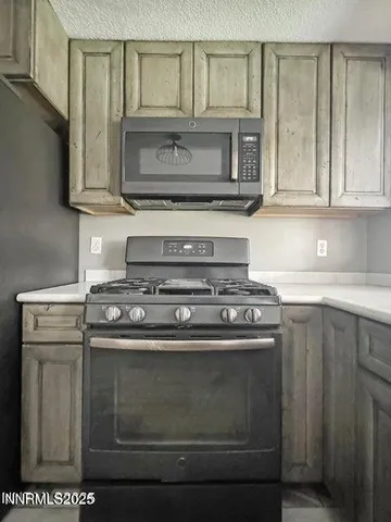a stove top oven sitting inside of a kitchen