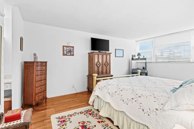 a bedroom with a bed and flat screen tv