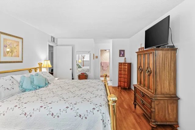 a bedroom with furniture and a flat screen tv