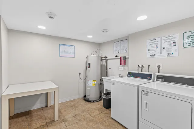 a view of a storage & utility room with dryer and washer