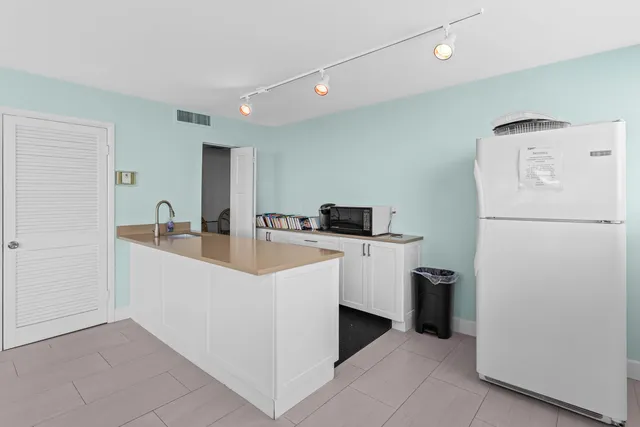 a kitchen with a refrigerator a sink and dishwasher