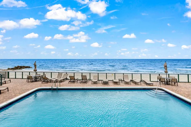 a view of a swimming pool and outdoor seating