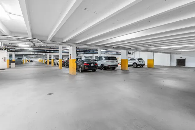 a view of parking garage with cars