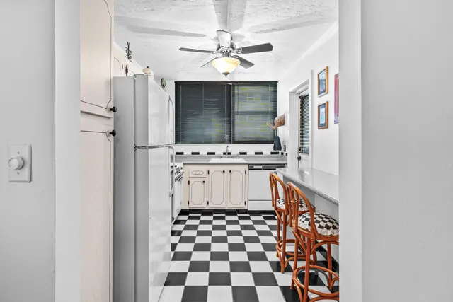 a kitchen with stainless steel appliances a stove a refrigerator and a window