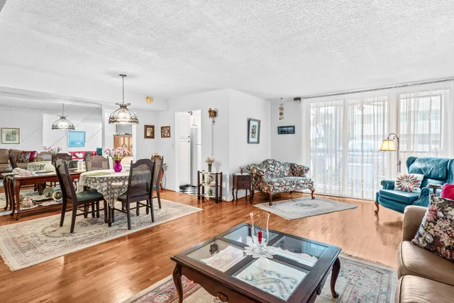 a living room with furniture a flat screen tv and a large window