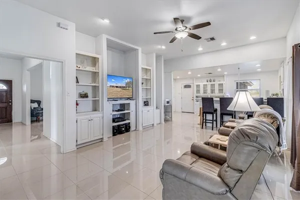 a living room with furniture and kitchen view