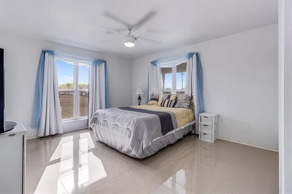 a bedroom with a bed lamp and window