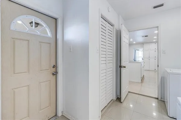 a view of a hallway with wooden shelves