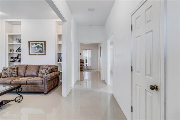 a living room with furniture and a walk in closet