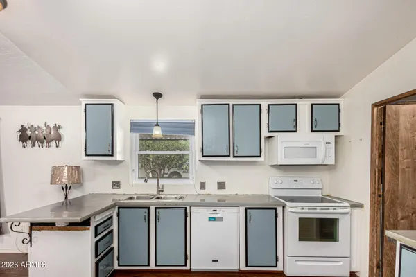 a kitchen with a sink stove and refrigerator