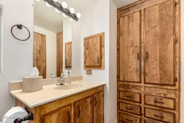 a bathroom with a granite countertop sink and a mirror