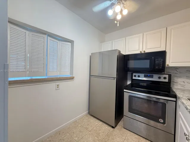 a kitchen with a refrigerator stove and microwave