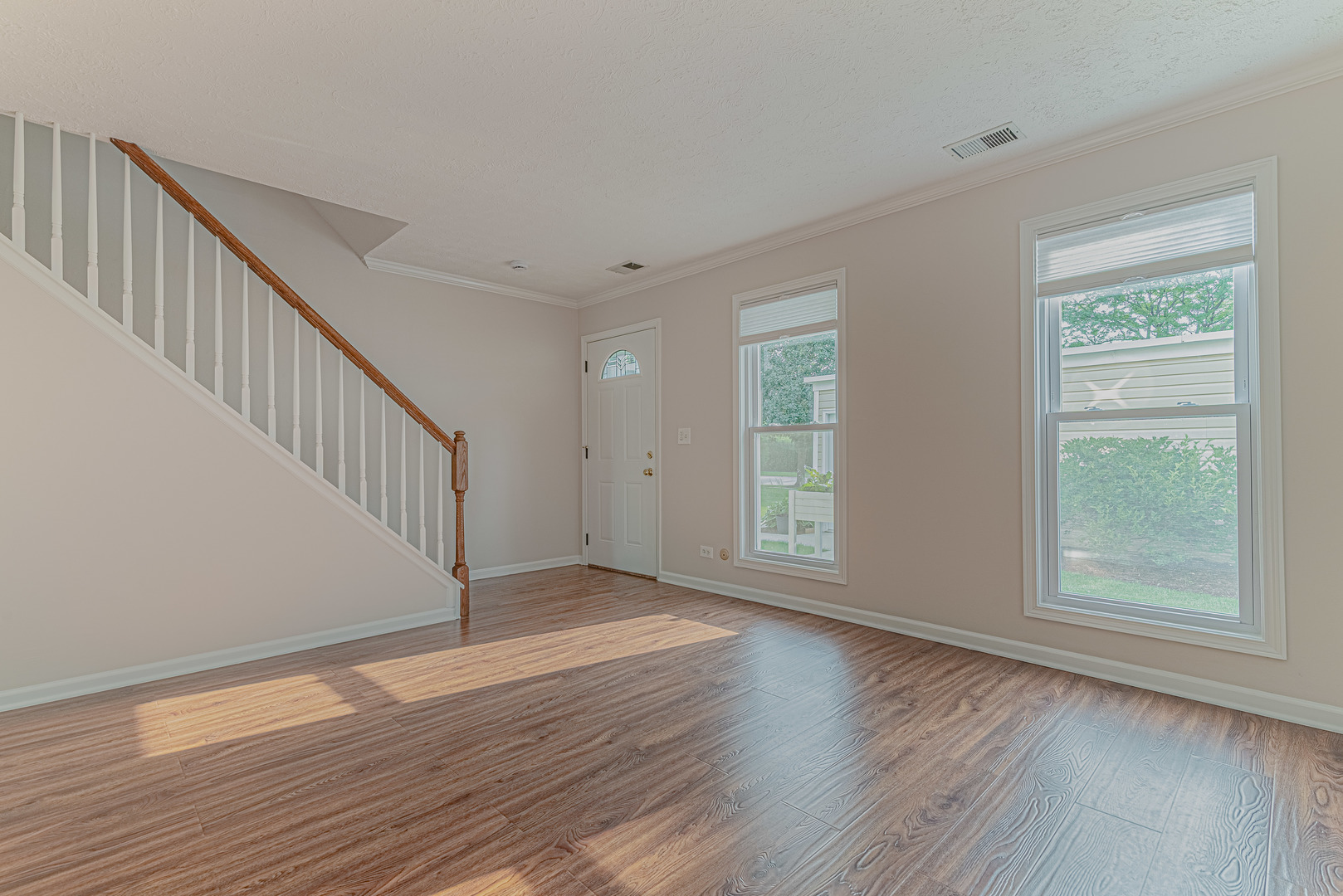 184 Rodenburg Road Roselle, IL 60172 - Photo 4 of 29 a view of an empty room with wooden floor and a window
