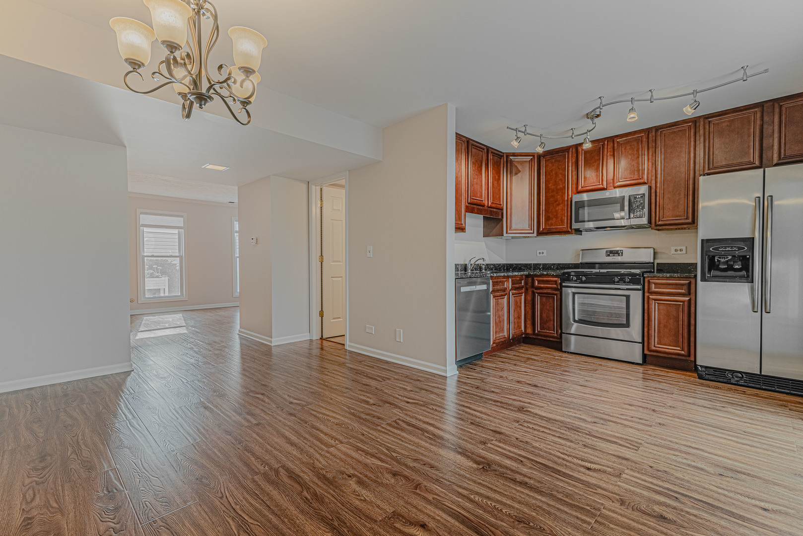 184 Rodenburg Road Roselle, IL 60172 - Photo 6 of 29 a view of kitchen with stainless steel appliances granite countertop a stove top oven a refrigerator with wooden floors and cabinets